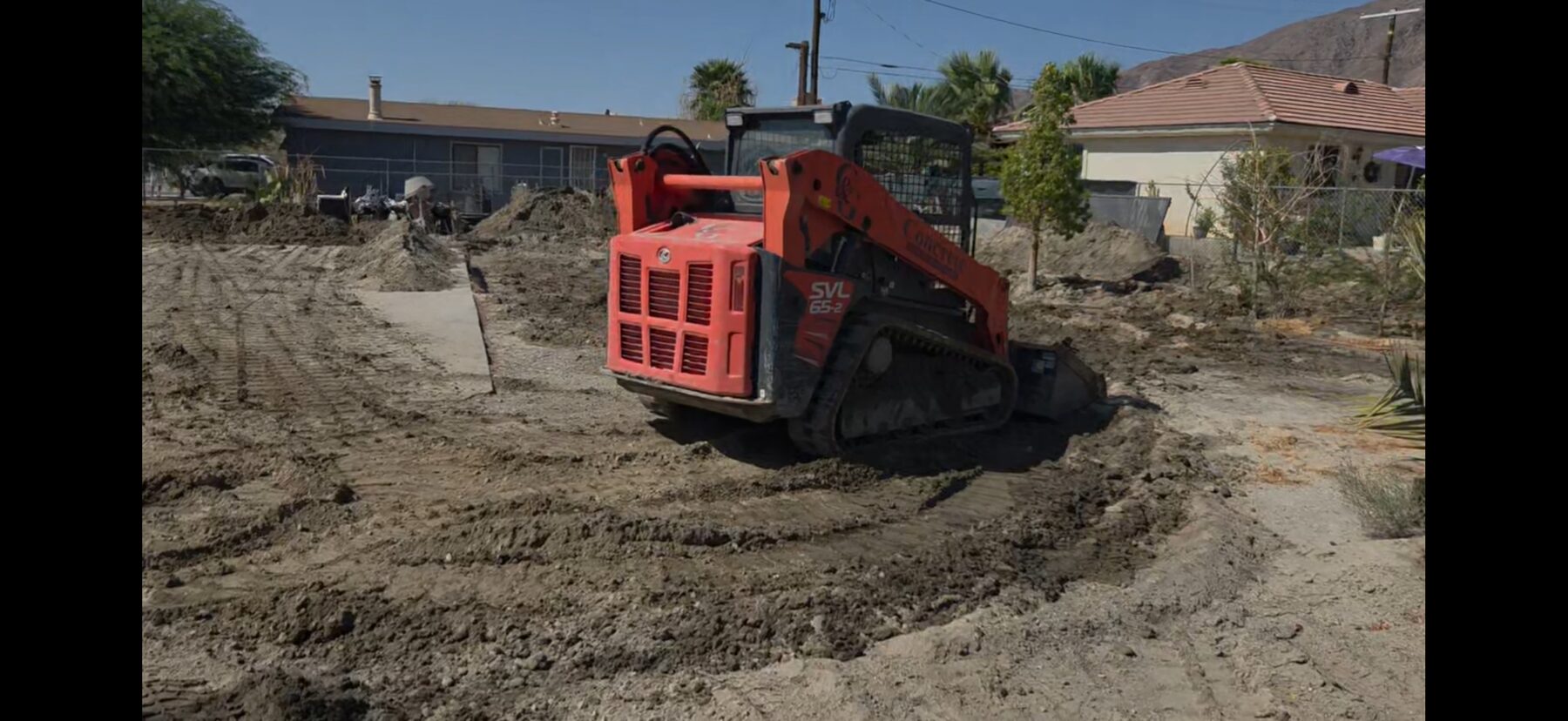 Skid steer excavating a foundation footing on a West Shores jobsite